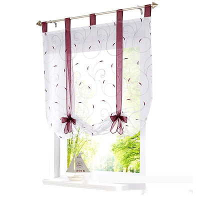 White sheer Roman window screen with red embroidered floral patterns and red ribbon ties, hanging from a silver rod. - Image 3