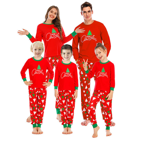 Family of five wearing matching red and navy blue Christmas pajamas with reindeer tops and fair isle pants. - Image 2