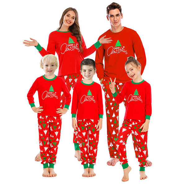 Family of five wearing matching red and navy blue Christmas pajamas with reindeer tops and fair isle pants. - Image 2