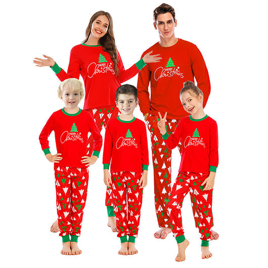 Family of five wearing matching red and navy blue Christmas pajamas with reindeer tops and fair isle pants. - Image 2