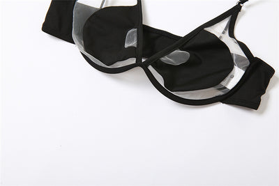 Woman wearing a white two-piece bikini with a bralette top featuring sheer cut-outs and a high-cut thong bottom with multiple straps. - Image 2
