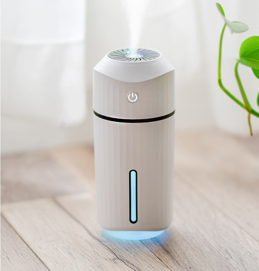 Pink columnar mini car humidifier with a power button and a clear water level indicator on a white background. - Image 16