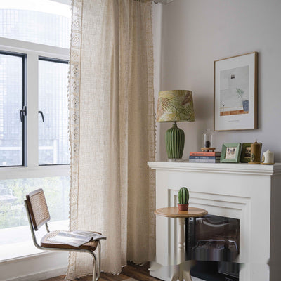 Close-up of a beige semi-transparent curtain with a delicate crochet lace trim and decorative tassels. - Image 20