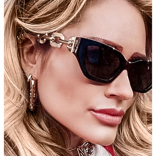 Red cat-eye sunglasses with dark lenses and gold-colored chain link temples on a white background. - Image 8