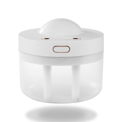White portable projection humidifier with a translucent water tank and gold-accented control buttons. - Image 9