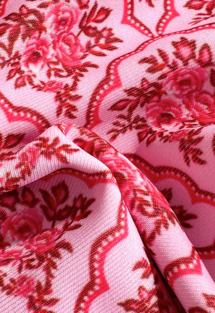 Pink two-piece bikini with a red floral and geometric print, featuring a bandeau top and high-cut bottoms. - Image 13