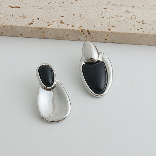 Pair of gold-toned irregular earrings with black onyx-like inserts, featuring a modern, abstract design. - Image 29