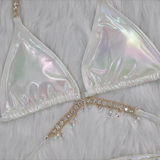 Iridescent purple and pink two-piece bikini with gold-toned crystal embellishments on a white faux fur background. - Image 25