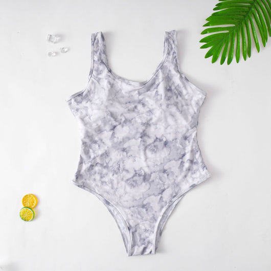 Purple tie-dye one-piece swimsuit with a scoop neck, worn by a person in a poolside setting. - Image 4