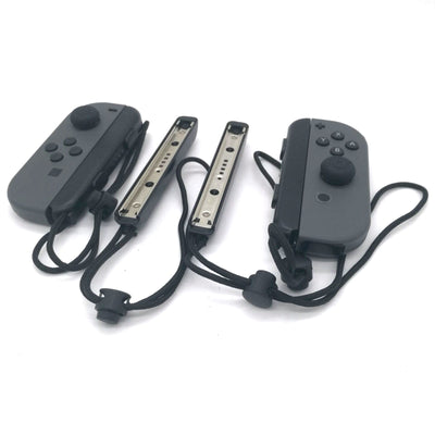 Two black Nintendo Switch Joy-Con wrist straps, one showing internal metal rail, the other with buttons and lanyard. - Image 9