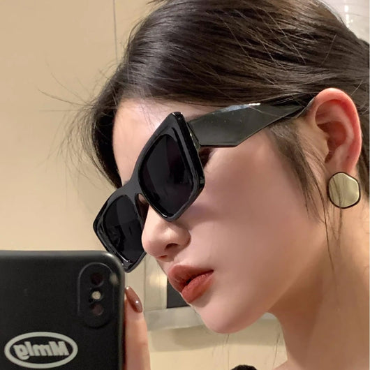 Retro cat-eye sunglasses with a vibrant orange frame, brown temples, and light champagne-colored lenses. - Image 4