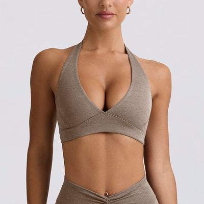 Light pink halter neck sports bra and high-waisted leggings workout set on a model. - Image 6