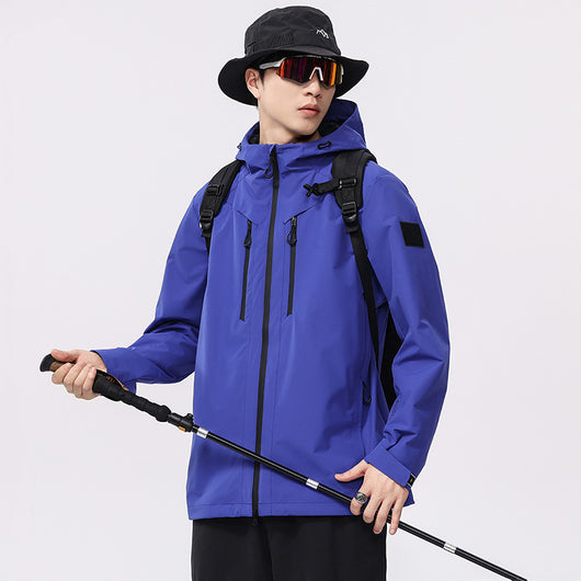 Man wearing a black windproof and waterproof outdoor jacket with a hood, sports sunglasses, and a bucket hat, holding a trekking pole. - Image 4