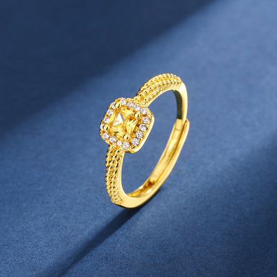 Women's gold-toned jewelry set with a ring, necklace, and stud earrings, each featuring a square yellow gemstone surrounded by small clear stones. - Image 4