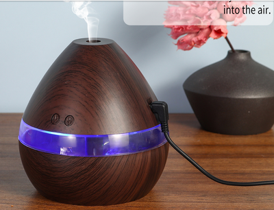 Light wood grain teardrop ultrasonic humidifier and essential oil diffuser with a clear LED light band. - Image 7