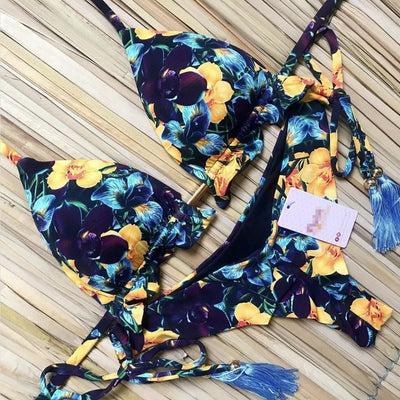 Women's tropical floral print bikini with a halter top, ruffled edges, and tie-side bottoms with pink tassels. - Image 20