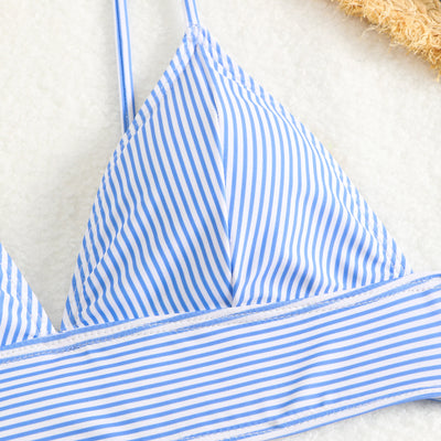 Green and white striped two-piece bikini with a triangle top and high-waisted bottoms on a woman. - Image 29