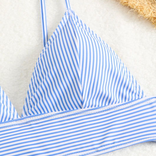 Green and white striped two-piece bikini with a triangle top and high-waisted bottoms on a woman. - Image 29