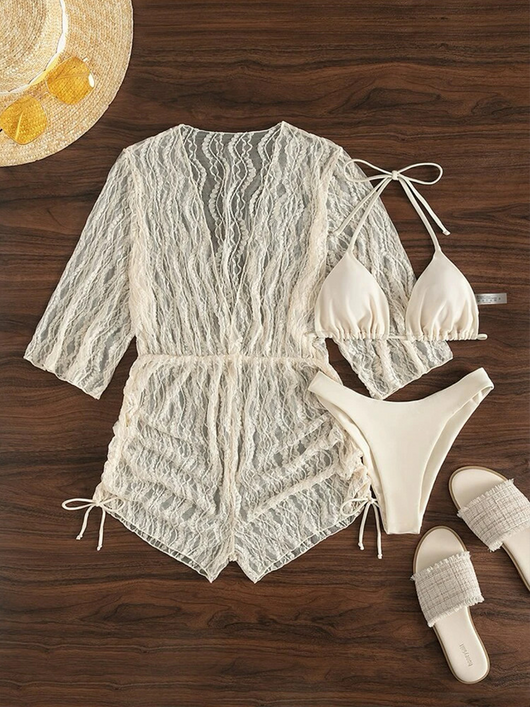 Woman wearing a white and black tie-dye beach cover-up romper with a deep V-neck and drawstring sides. - Image 21