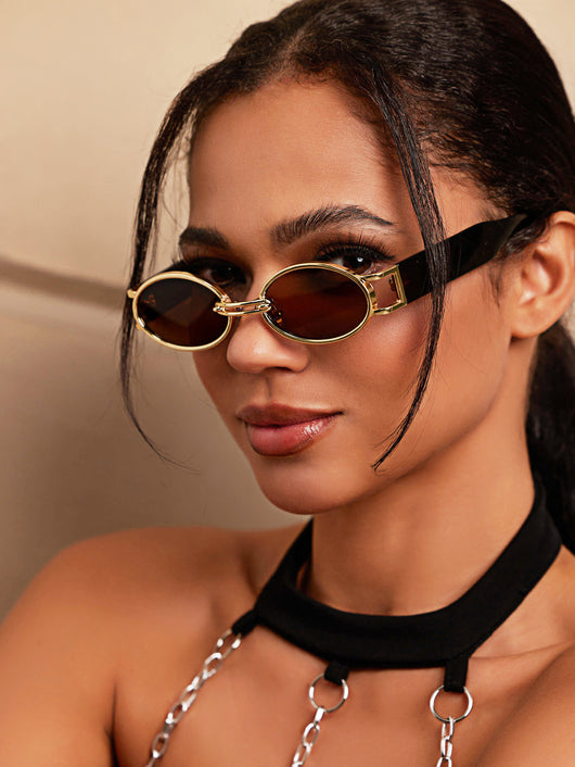 Retro small frame sunglasses with gold round frames and leopard print temples, held by a hand. - Image 19