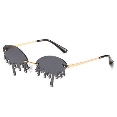 Rimless sunglasses with dark gray dripping liquid-shaped lenses, silver studs, and gold metal frames. - Image 11