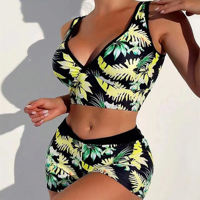 Two-piece swimsuit with a black background and vibrant pink and purple tropical floral print. Features a V-neck crop top and high-waisted boxer shorts. - Image 3