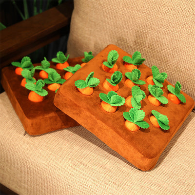 Brown plush snuffle mat with ten orange carrot-shaped toys, each with green leafy tops, for pet foraging and play. - Image 17