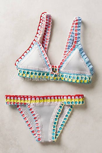 Pink crocheted bikini with silver knitted stitching, featuring a triangle top and matching bottom, laid flat. - Image 12