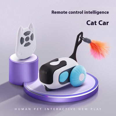 White and black remote control cat toy car with purple wheels and an orange feather, next to a white cat-shaped remote. - Image 7