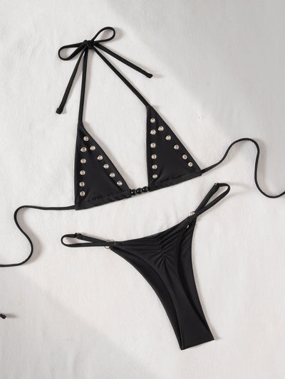Black tie-front bikini swimsuit with silver grommets on the triangle top and a ruched thong bottom, laid flat. - Image 16