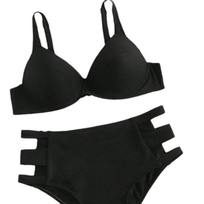 Dark green hard cup bikini with high-waisted bottoms featuring side cut-outs, worn by a woman lying on a bed. - Image 3