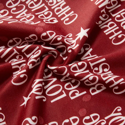 Family of four in matching Christmas pajamas: white tops with red tree graphic, red bottoms with white text. - Image 19