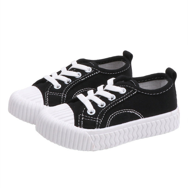 Pair of black canvas children's shoes with white laces and white rubber toe cap and sole. - Image 6