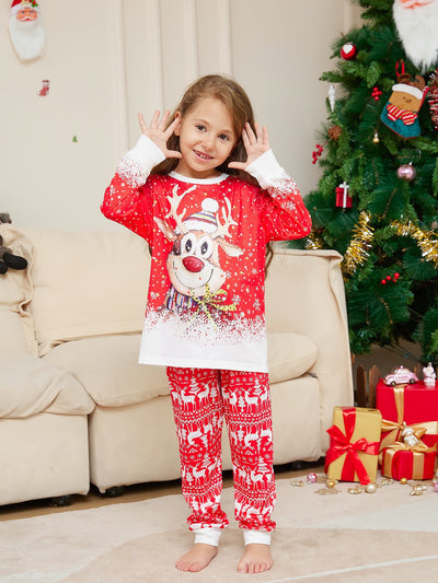 Family of four wearing matching red Christmas pajamas with reindeer and snowflake print, plus red pom-pom beanies. - Image 6