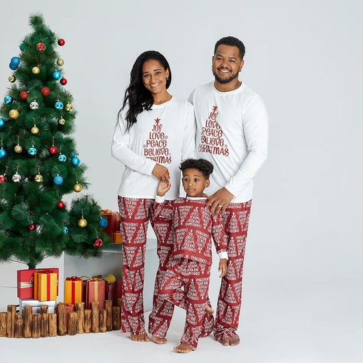 Family of four in matching Christmas pajamas: white tops with red tree graphic, red bottoms with white text. - Image 15
