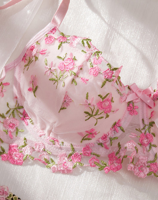 Pink floral embroidered lace lingerie set with bra, garter belt, and thong on a white textured background. - Image 11