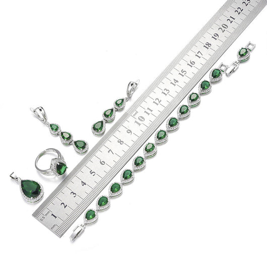 Green pear-shaped gemstone jewelry set with necklace, dangle earrings, ring, and bracelet, all with clear stone accents. - Image 10