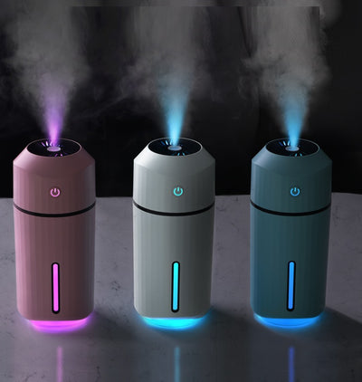 Pink portable humidifier with a power button, water level indicator, USB charging cable, and two cotton swabs. - Image 10