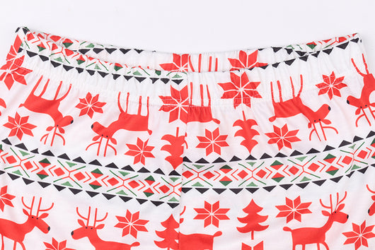 Mother and two daughters in matching red and white reindeer and snowflake print long-sleeve Christmas pajamas. - Image 5