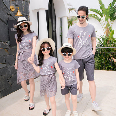 Family of four in matching grey "BE MINE" outfits. Mother and daughter wear lace skirts, father and son wear shorts. - Image 8