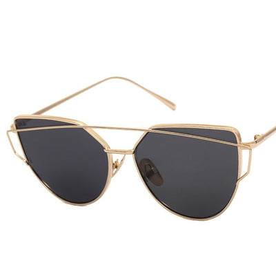Ultralight women's cat-eye sunglasses with a gold metal frame, dark gray lenses, and a distinctive double bridge. - Image 9