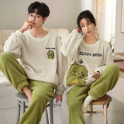 Couple wearing matching cream coral fleece pajamas with gray pants and bear embroidery, seated on a bed. - Image 6