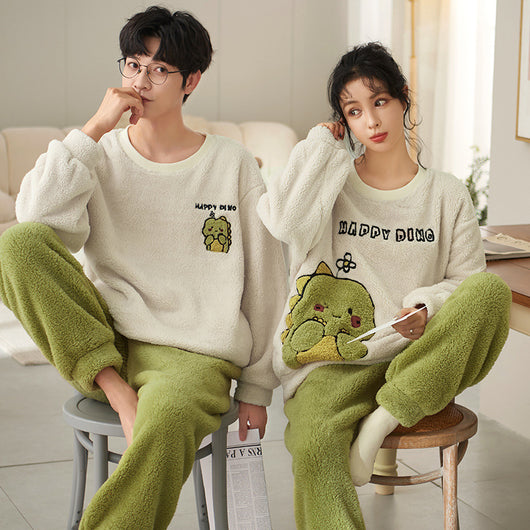 Couple wearing matching cream coral fleece pajamas with gray pants and bear embroidery, seated on a bed. - Image 6