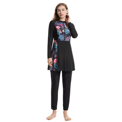 Woman in a navy blue quick-drying conservative swimwear set with a tropical leaf print tunic and matching swim cap. - Image 20
