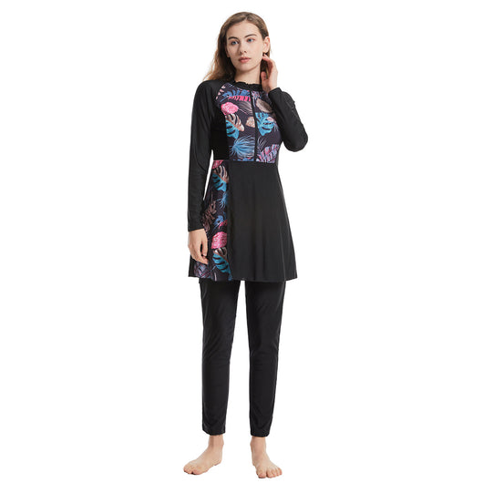 Woman in a navy blue quick-drying conservative swimwear set with a tropical leaf print tunic and matching swim cap. - Image 20