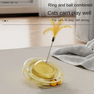 Yellow UFO tumbler cat toy with rolling balls, a clear dome, and a spring-mounted feather wand with a bell.