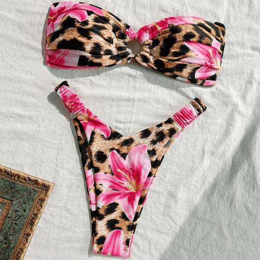 Women's tube top bikini swimsuit with a pink floral and leopard print, featuring a twisted front top and high-cut ruched bottom.