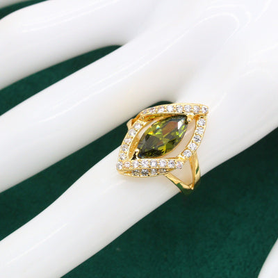 Gold-toned jewelry set with green marquise gemstones and clear accents, including a bracelet, necklace, earrings, and ring. - Image 11