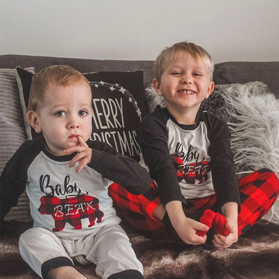 Family of three wearing matching Christmas pajamas with white tops, black raglan sleeves, and red buffalo plaid bear graphics, paired with red and black buffalo - Image 6