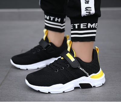 Boy's black and blue sports shoes with orange accents, mesh upper, white sole, blue laces, and a Velcro strap. - Image 19